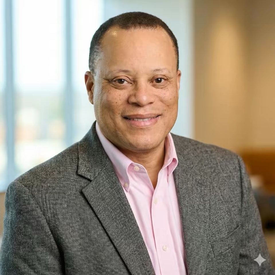 Floyd J. Sanders in a gray blazer and pink shirt